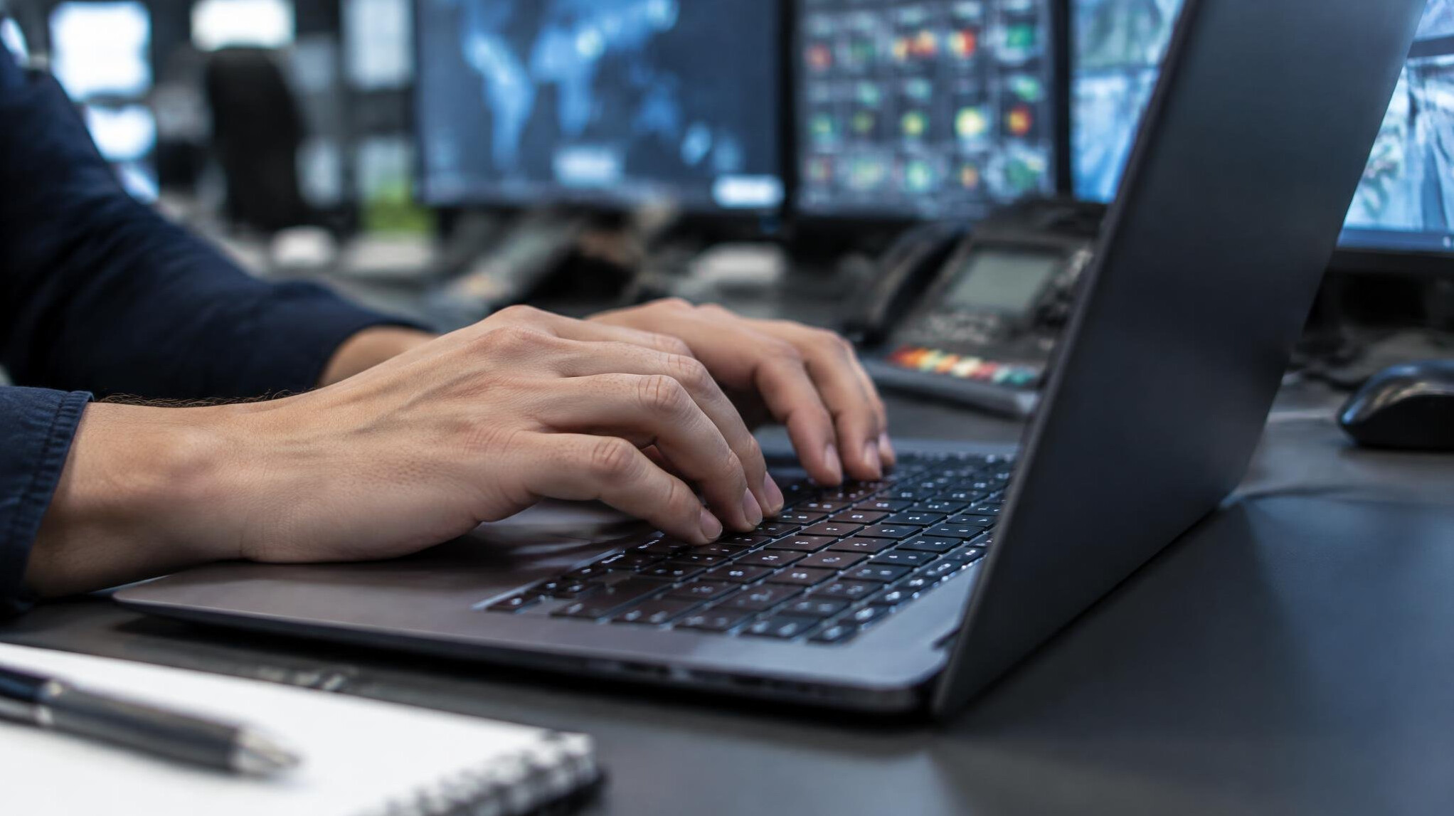 Hands typing on a laptop keyboard